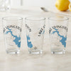 Three clear glasses with Lake Livingston map and compass designs.