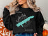 Black sweatshirt with "Beautiful Sardis Lake Mississippi" map and compass graphic.