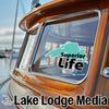 Sticker on boat window with "Superior Life" text and Lake Superior shape; Lake Lodge Media logo.