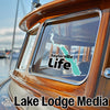 Sailorville Life logo on boat window, Lake Lodge Media branding below.