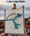 Woven blanket with Nantahala Lake map and compass design, held by a smiling man.