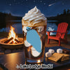 A tall glass of iced coffee with whipped cream, beside s'mores ingredients.
