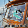 "Arkabutla Life" decal with a lake outline on a boat window, "Lake Lodge Media" text below.