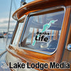 Mint green "Banks Life" sticker on a boat window, with "Lake Lodge Media" text.