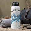 White water bottle with blue map graphic and "MINNETO" text on textured surface.