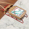 Wooden sled ornament with red accents and Merry Christmas text from Willow Springs.
