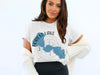 White t-shirt with Forest Lake Minnesota graphic and compass rose design.