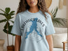 Light blue t-shirt with blue map outline and compass graphic that reads "Lakewood Lakes Missouri".