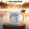White mug with Lake Lotawana Missouri map and compass design on waterfront background.