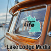 "Lawtonka Life" decal on a boat window with "Lake Lodge Media" below.