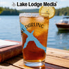Glass of iced tea with blue duck and compass design, lemon slice.