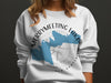 White sweatshirt with Merrymeeting Lake New Hampshire map and compass design.