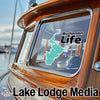 Turquoise map decal with "Buchanan Life" sticker on a boat window.