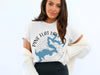 White t-shirt with "Pine Flat Lake California" text and compass graphic.