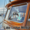 "Randleman Life" sticker on wooden boat window with "Lake Lodge Media" text.