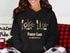 Black hoodie with "Forest Lake, Minnesota" text and nautical graphics.