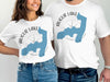 White t-shirts with Augur Lake, New York map and compass design.