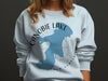 Sweatshirt with blue silhouette of Canobie Lake, New Hampshire and compass design.