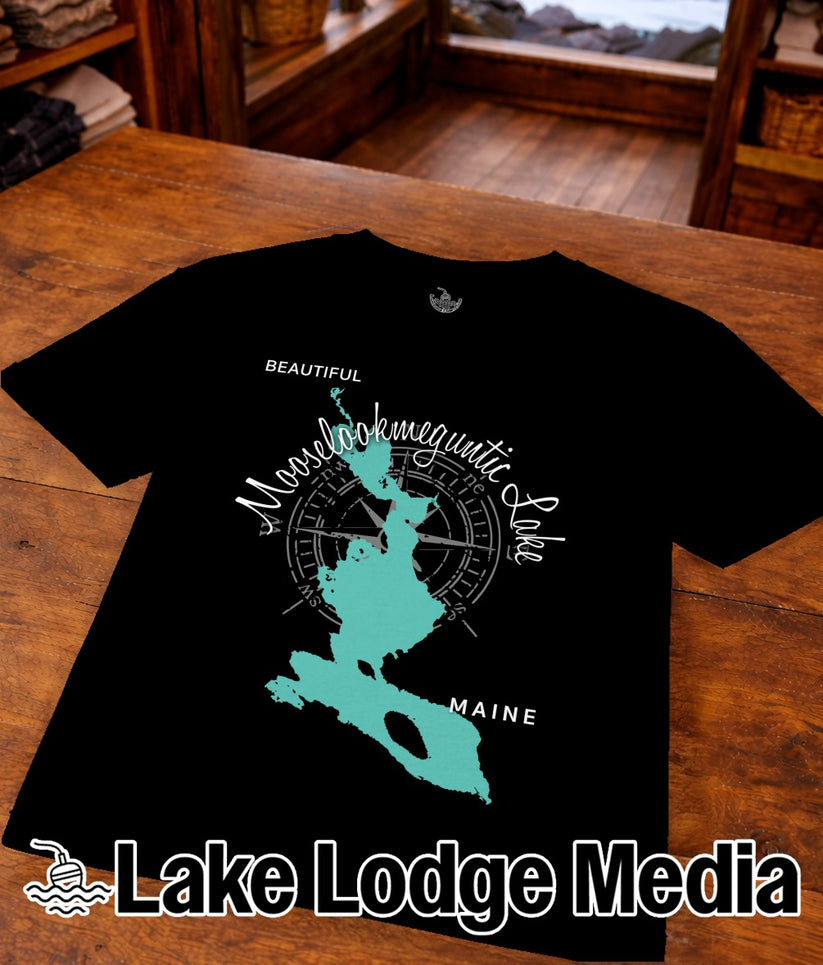 Black t-shirt with turquoise map of Moosehead Lake and "Lake Lodge Media" text.