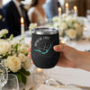 Black tumbler with Apache Lake map and compass design, held by hand at a table.