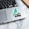 Green Lakewood Life sticker on a laptop with a marble background.