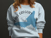 White crewneck sweatshirt with Lake Gregory California map and compass design.
