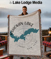 Man holding a blanket with Ashokan Lake map and compass design.