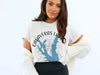 White t-shirt with Calaveras Lake Texas map and compass graphic.