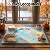 Glass cutting board featuring a map of Lake Darling, Iowa, with crackers, cheese, and fruit.
