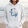 White hoodie with Medina Lake Texas map and compass graphic.