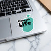 Pulaski Life sticker on a laptop keyboard with a teal shape.