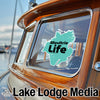 Turquoise "Moultrie Life" sticker on a boat window with "Lake Lodge Media" text below.