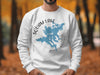 White sweatshirt with a blue Squam Lake, New Hampshire map and compass graphic.