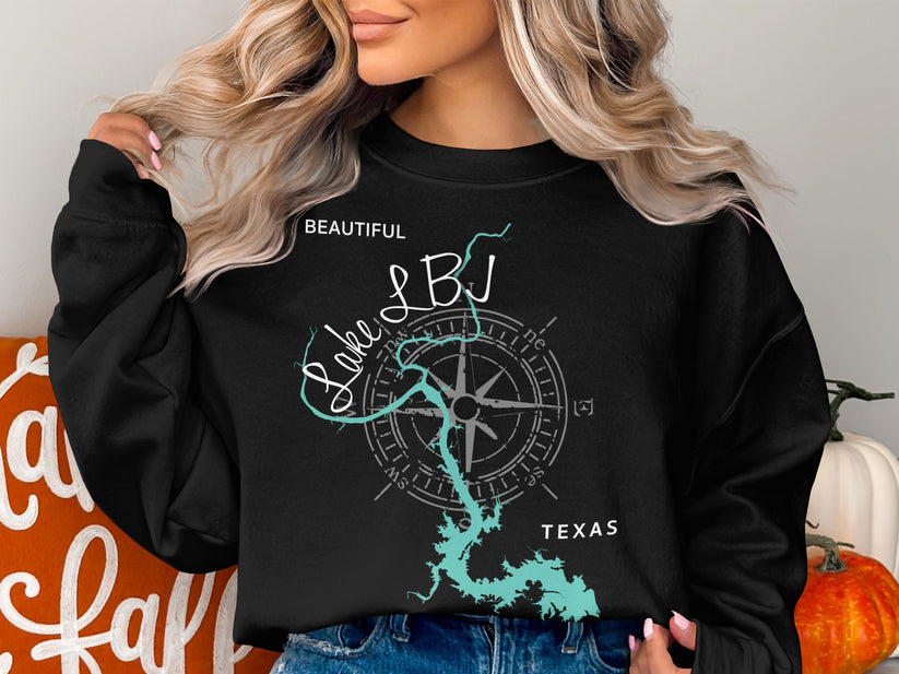 Black sweatshirt with "Beautiful Lake LBJ Texas" and compass on dark background.