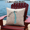 Beige pillow with "Torch Lake Michigan" and compass design on Adirondack chair.