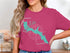 Pink t-shirt featuring a turquoise map outline of Bass Lake, California.