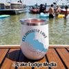 A white stainless steel tumbler with a Clearwater Lake, Minnesota graphic sits on a wooden dock with people swimming in a lake in the background.