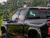 Black truck with "Lake Lodge Media" and "Forest Life" decals on the rear window.