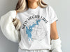 New Hogan Lake California text over a compass and lake map graphic on a white t-shirt.