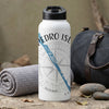 White water bottle with "PEDRO ISL" text, compass graphic, and "FL" on a textured surface.