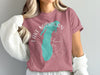 Pink t-shirt with "Lake Michigan" text and a turquoise map outline over a compass.