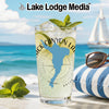 Glass with Black Canyon Lake Arizona design, limes, mint, and ice on beach.