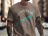Man wearing a taupe t-shirt with a compass and Wisconsin map graphic.