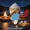 Dessert with whipped cream, layered with coffee and caramel, near a campfire and lake.