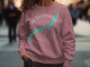 Pink crewneck sweatshirt with Lake Ullswater map and compass rose graphic.