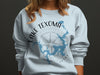 Light blue sweatshirt with Lake Texoma map and compass graphic.