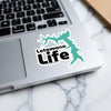 Lotawana Life sticker with lake outline on laptop keyboard