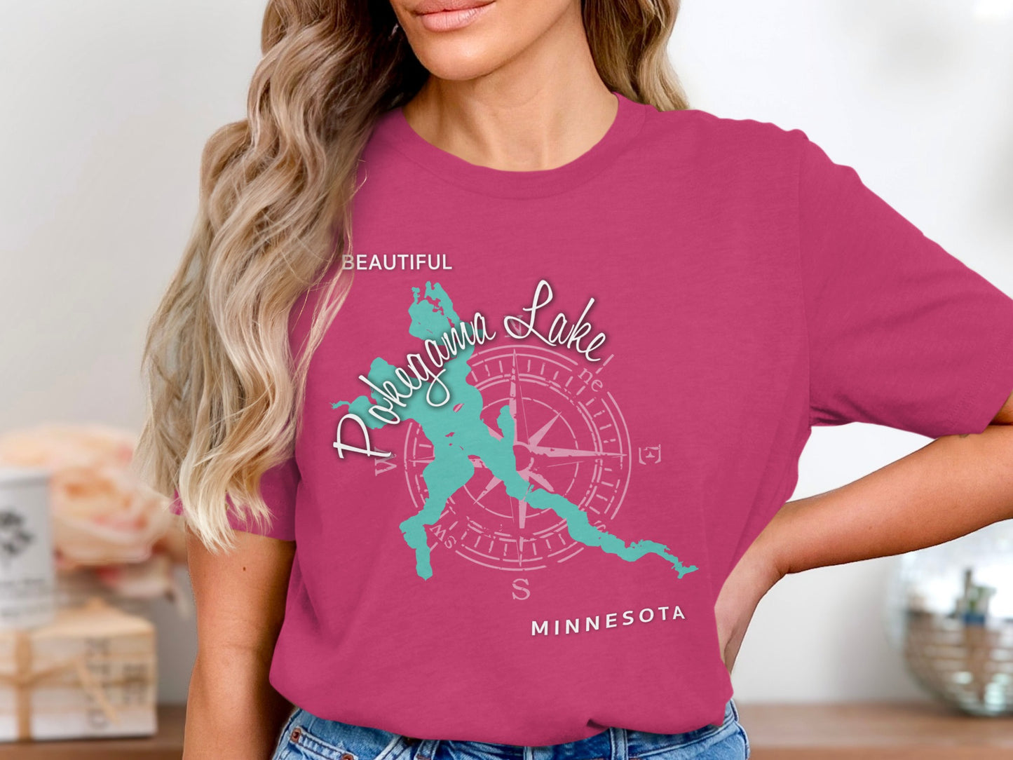 Teal Pokegama Lake Minnesota graphic on a pink t-shirt.