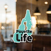 Turquoise sticker with "Payette Life" text on a blurred background.