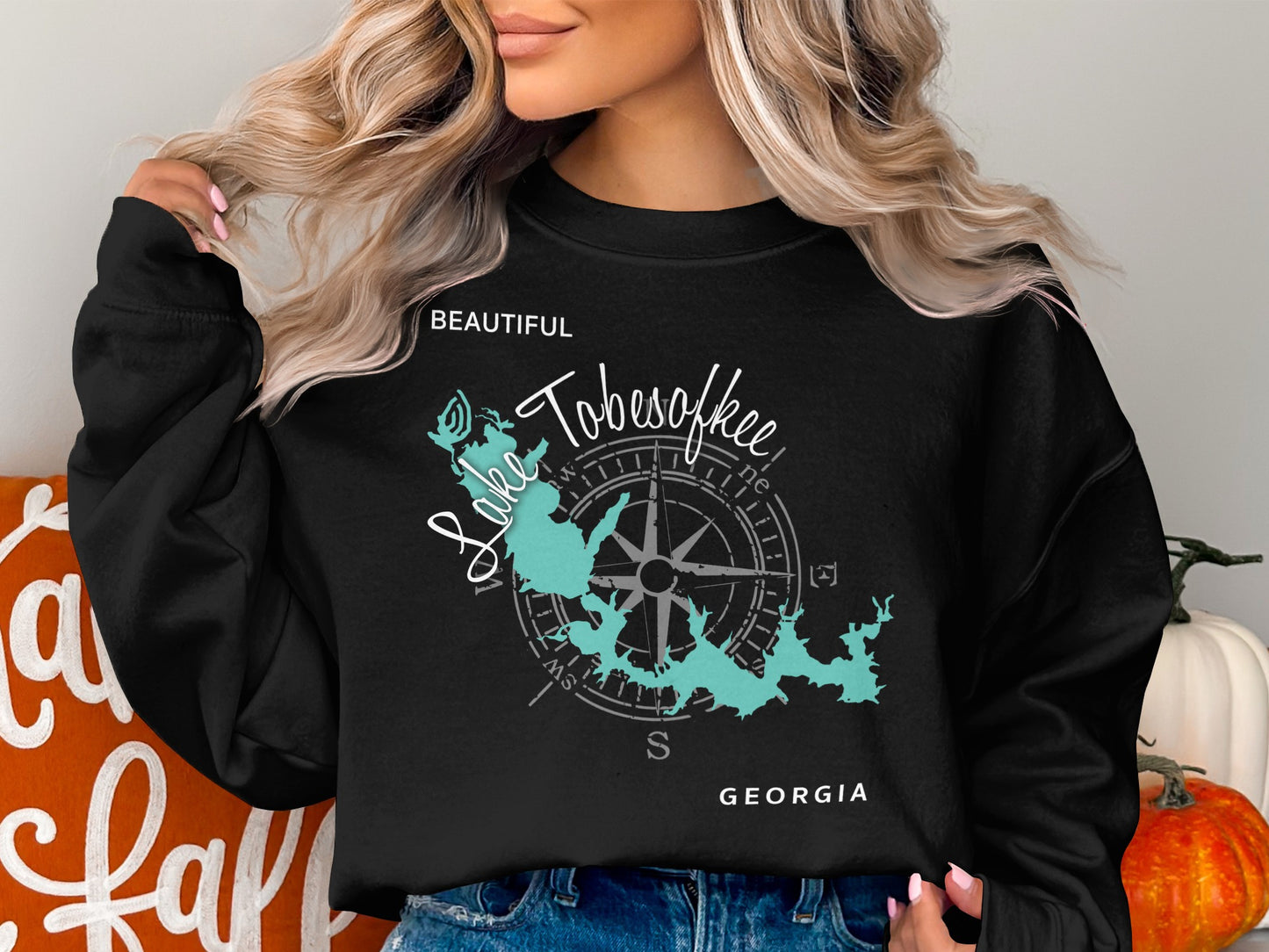 Black sweatshirt with a teal map of Lake Tobesofkee, Georgia and compass.